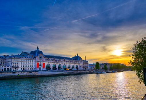 Paris, France - April 21, 2019 - A view of the Musee d'Orsay along the River Seine at sunset in Paris, France.