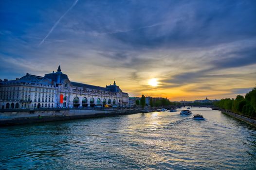 Paris, France - April 21, 2019 - A view of the Musee d'Orsay along the River Seine at sunset in Paris, France.