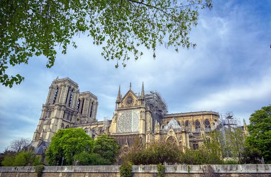 Paris, France - April 21, 2019 - Notre Dame Cathedral on the Seine River in Paris, France after the fire on April 15, 2019.