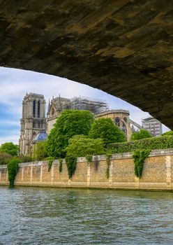 Paris, France - April 21, 2019 - Notre Dame Cathedral on the Seine River in Paris, France after the fire on April 15, 2019.