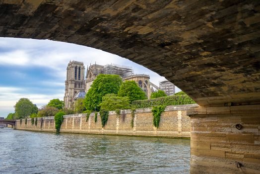 Paris, France - April 21, 2019 - Notre Dame Cathedral on the Seine River in Paris, France after the fire on April 15, 2019.