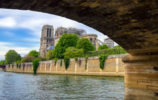 Paris, France - April 21, 2019 - Notre Dame Cathedral on the Seine River in Paris, France after the fire on April 15, 2019.