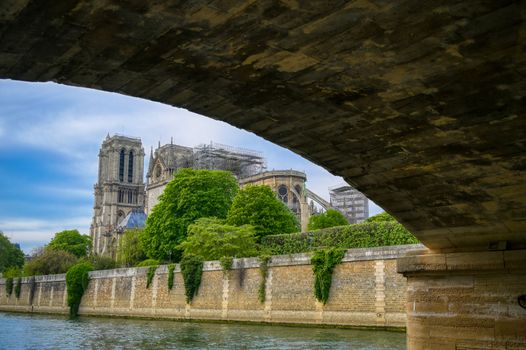 Paris, France - April 21, 2019 - Notre Dame Cathedral on the Seine River in Paris, France after the fire on April 15, 2019.