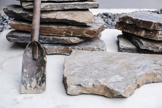Shovel and stone cladding for garden decoration