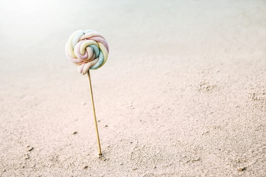 Lollipop of marshmallow on the beach minimal summer