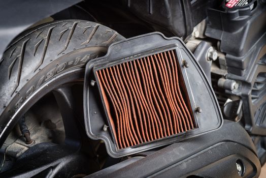 closeup worn motorcycle air filter. Motorcycle maintenance concept.