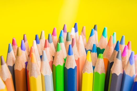Back to school set multicolored pencils colorful making forms side view on a yellow backround