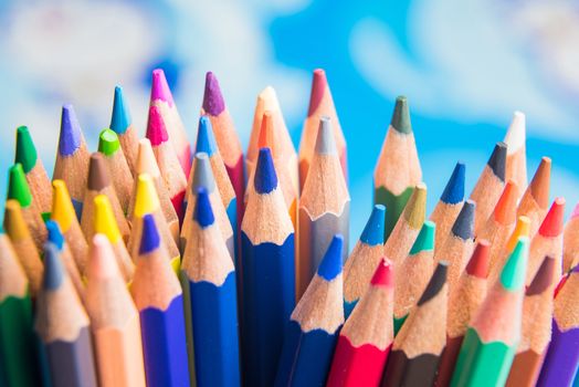 Back to school set multicolored pencils colorful making forms side view on a bule backround