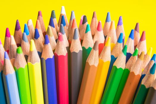 Back to school set multicolored pencils colorful making forms side view on a yellow backround