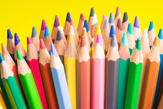 Back to school set multicolored pencils colorful making forms side view on a yellow backround