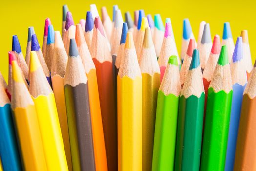 Back to school set multicolored pencils colorful making forms side view on a yellow backround