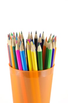 Color pencils in the orange prop over white. Shallow DOF.