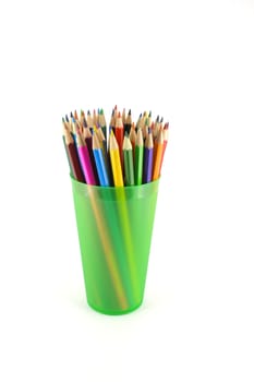 Color pencils in the green prop over white
