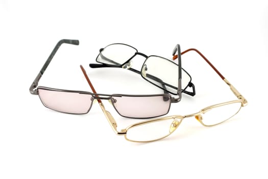 Three optical glasses over white