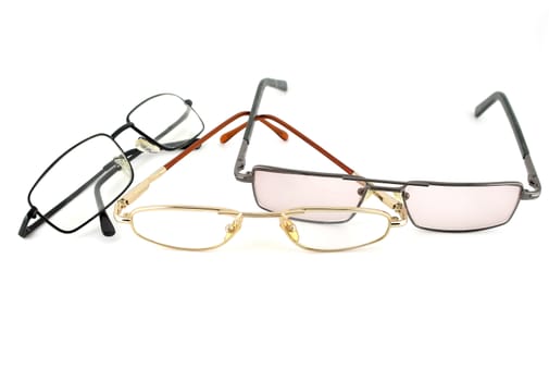 Three optical glasses over white