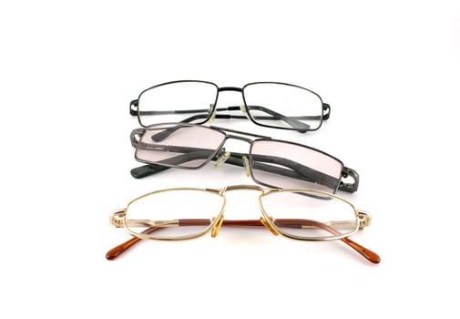 Three optical glasses over white