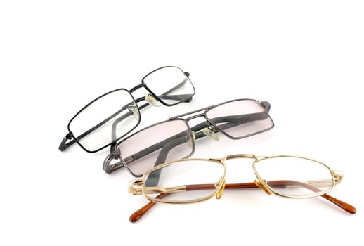 Three optical glasses over white