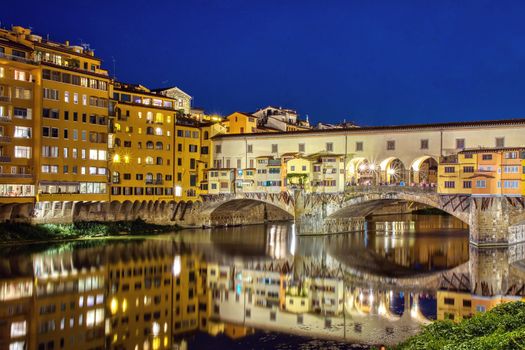 Florence, Italy - June 26, 2018: Ponte Vecchio in Florence, Italy, on a summer night. Thousands of tourists go through the bridge to day .