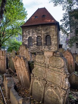 Prague, Czech Republic - September 26, 2018: Tombstones on Old Jewish Cemetery in the Jewish Quarter in Prague.There are about 12000 tombstones presently visible. One of the most important Jewish monument.