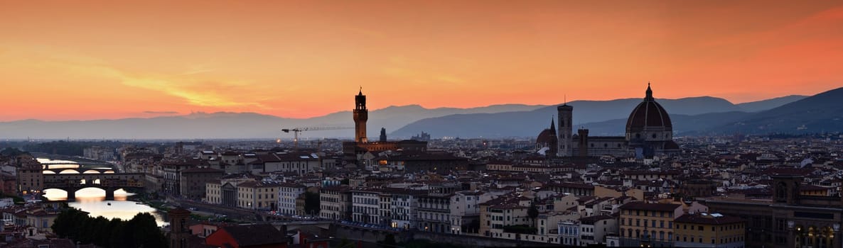 Panorama of Duomo Santa Maria Del Fiore, tower of Palazzo Vecchio and famous bridge Ponte Vecchio at sunset in Florence, Tuscany, Italy