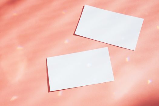 Flat lay of branding identity business name card on orange background with sparkle light and shadow, minimal design