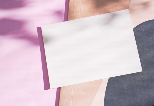 Flat lay of branding identity blank postcard on pink background with light and shadow from leaves botany, minimal concept for design