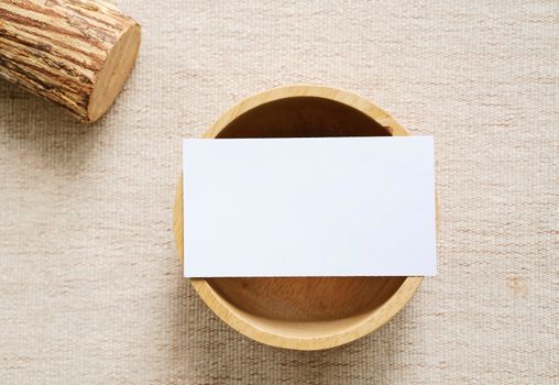 Flat lay of branding identity business name card on wooden container with fabric background, minimal concept for design