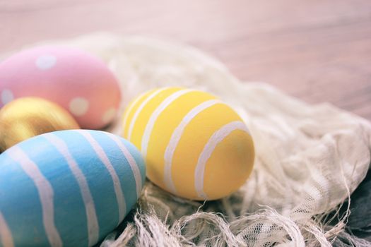 Pastel and colorful easter eggs on cloth with copy space, happy easter holiday concept