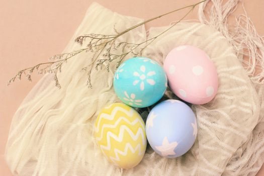 Pastel and colorful easter eggs on cloth with copy space, happy easter holiday concept