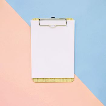 Blank clipboard on pastel color background, minimal style
