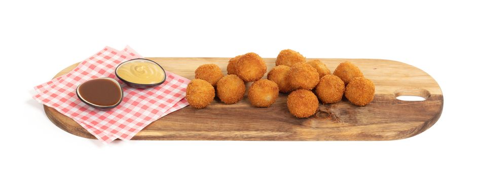 Dutch traditional snack bitterbal on a serving board, isolated