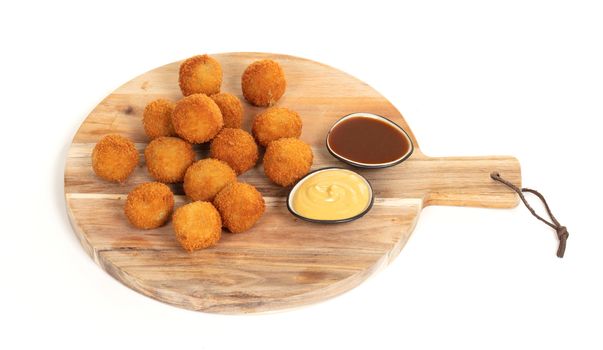 Dutch traditional snack bitterbal on a serving board, isolated