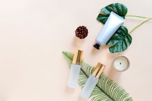 Flat lay of various organic skincare and beauty products for mock up with green leaves in minimal style