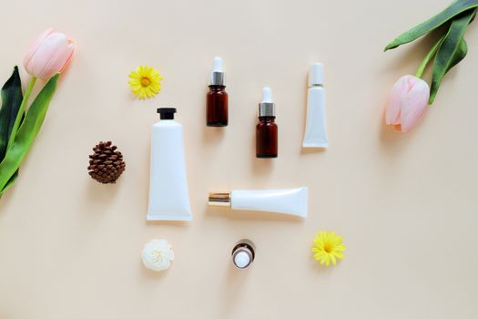 Flat lay of various organic skincare and beauty products for mock up with flower in minimal style