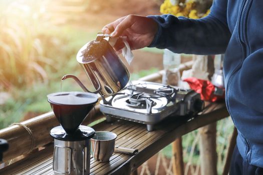 close up hands drip coffee with morning light 