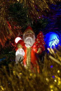 Closeup of Santa Claus figure on a Christmas tree as background