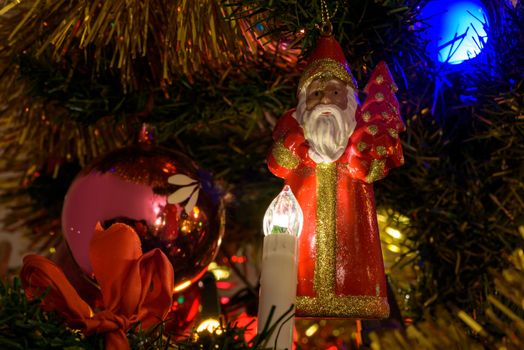 Closeup of Santa Claus figure on a Christmas tree as background