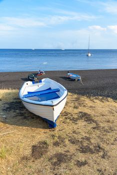 Boat on the black volcanic beach on Stromboli Island, Aeolian Islands, Italy