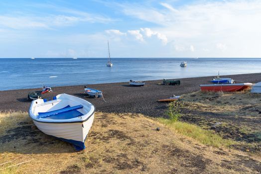 Boat on the black volcanic beach on Stromboli Island, Aeolian Islands, Italy