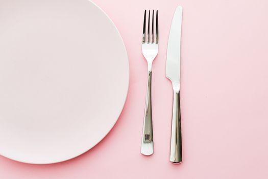 Empty plate and cutlery as mockup set on pink background, top tableware for chef table decor and menu branding design