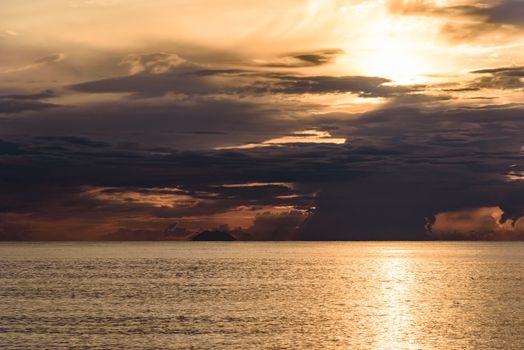 Dark clouds at sunset on the Tyrrhenian Sea with Stromboli vulcano in the background