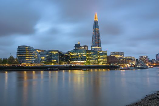 Colorful London skyline over River Thames at dusk on a cloudy day, United Kingdom