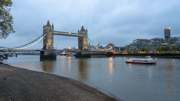 View of thr Tower Bridge in London at dusk on a cloudy day