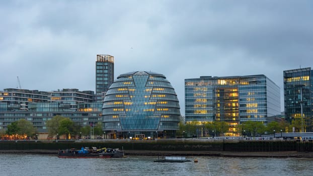 South bank of the River Thames in London at dusk on a cloudy day