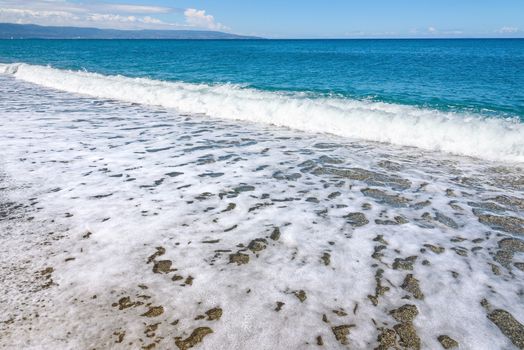 Summer background made of sea wave with withe foam