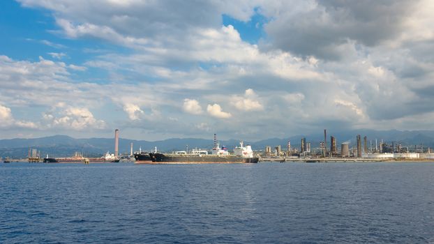 View of big ships in industrial zone in Milazzo on Sicily, Italy