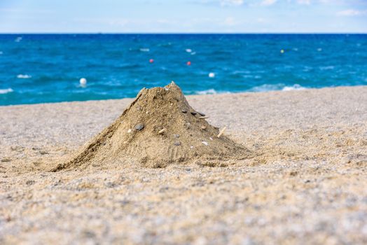 Volcano made from sand on the italian beach in Calabria