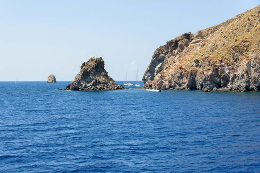 Yachts at the rocky coast of Lipari Island, Aeolian Islands, Italy