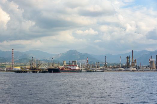 Industrial zone in Milazzo town on Sicily seen from the sea, Italy