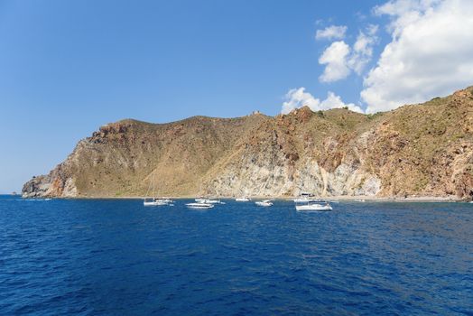 Yachts at the rocky coast of Lipari Island, Aeolian Islands, Italy